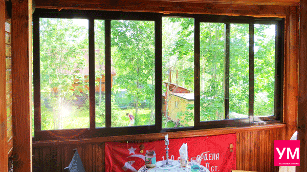 Пятистворчатое раздвижное окно коричневого цвета